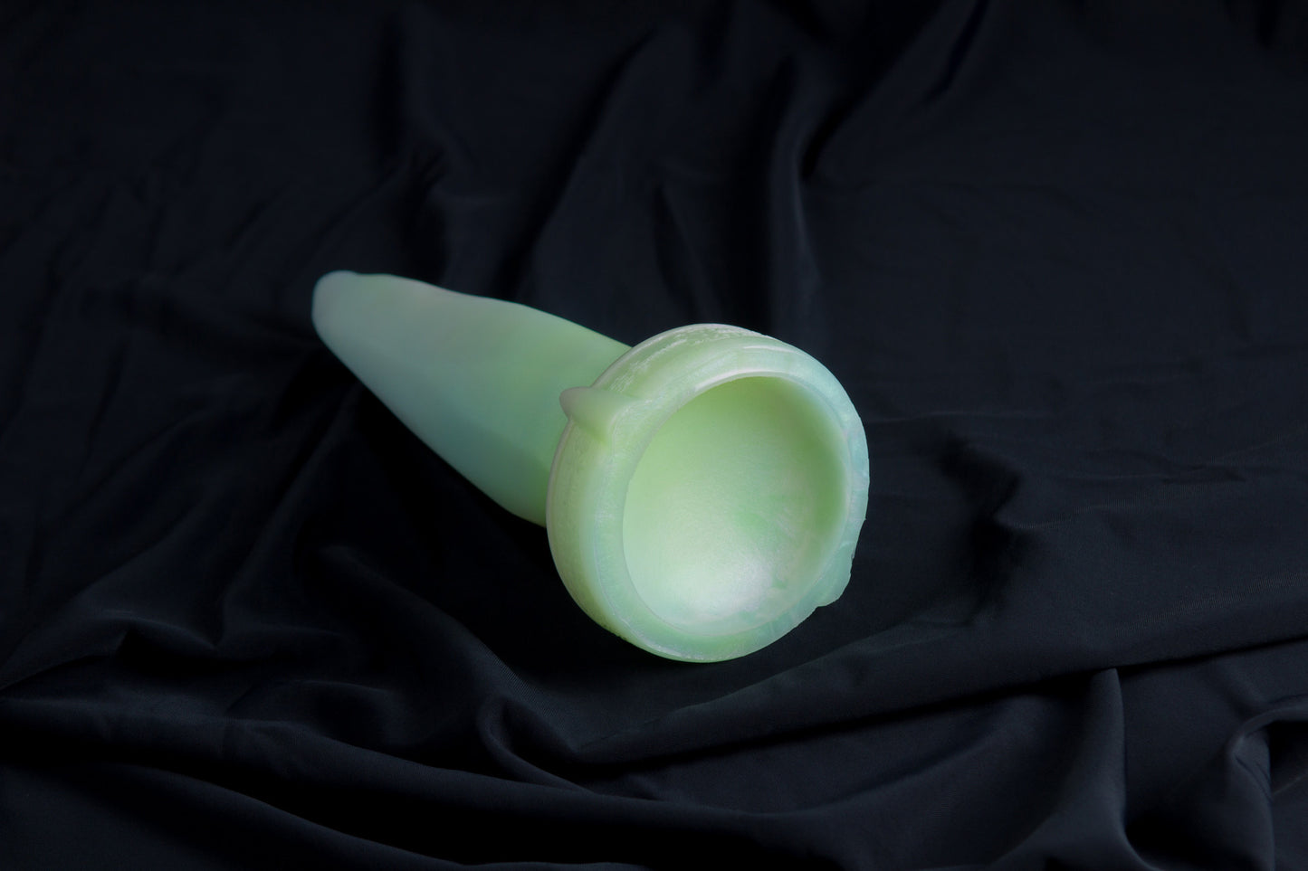Medium Bloomstone in glow in the dark white quartz color, soft firmness, with suction cup base