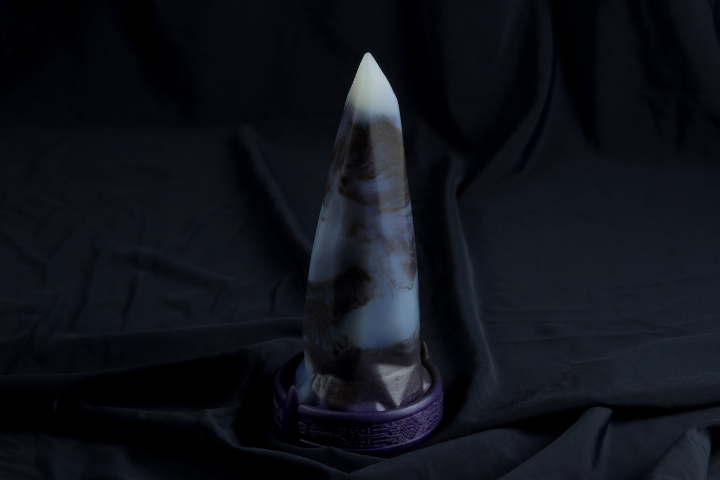 Medium Bloomstone in glow in the dark black marble color, soft firmness, with suction cup base