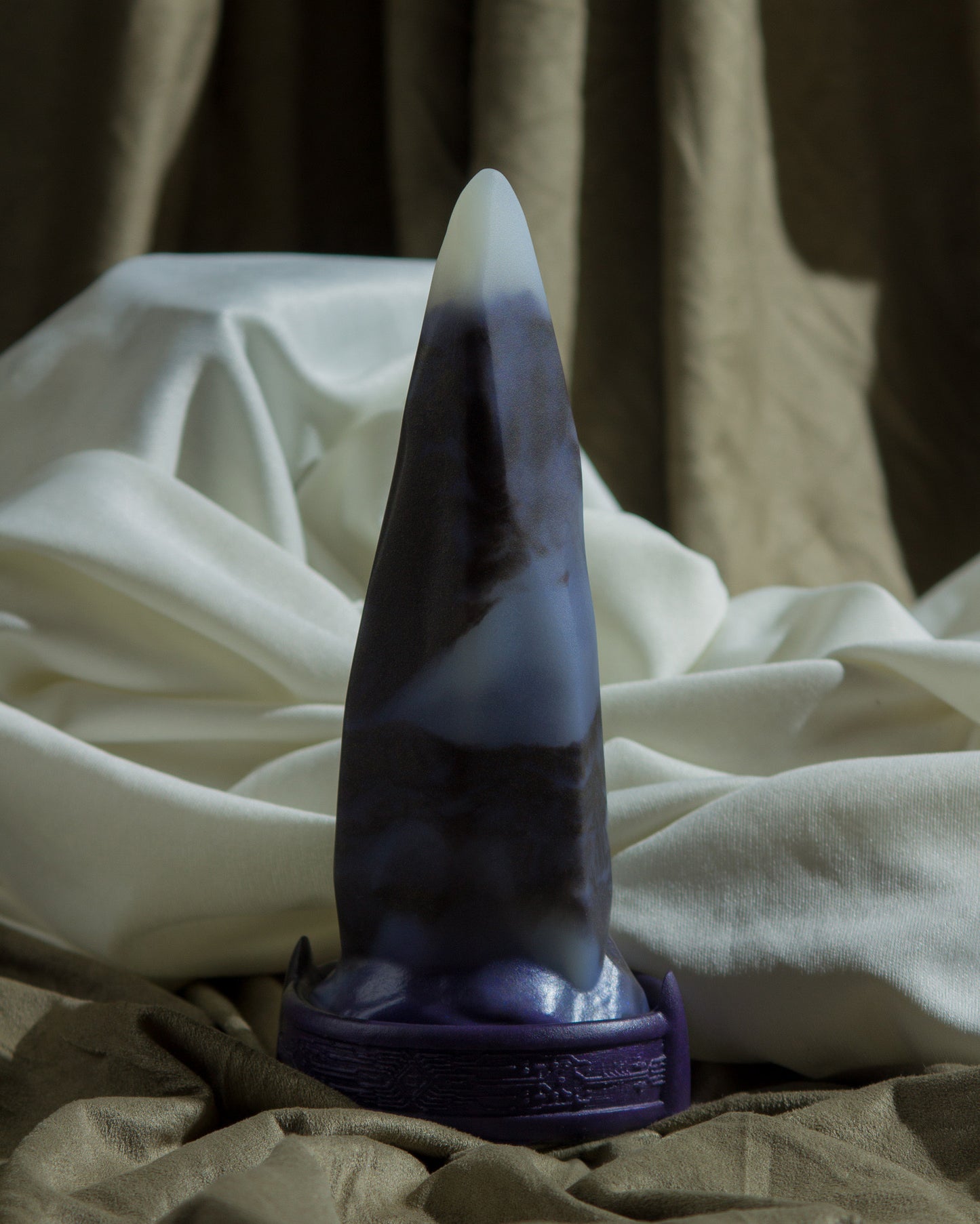 Medium Bloomstone in glow in the dark black marble color, soft firmness, with suction cup base